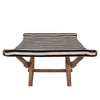 Fabric seat close up of foldable stool with wood frame and striped canvas seat