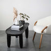 Creative Coop marble vase with round base and ridged straight neck on a coffee table with books and other decorative items