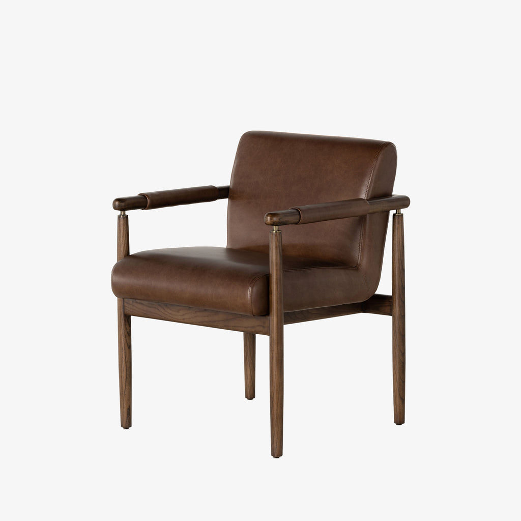 Brown leather 'Markia' arm dining chair with wood frame by four hands furniture on a white background