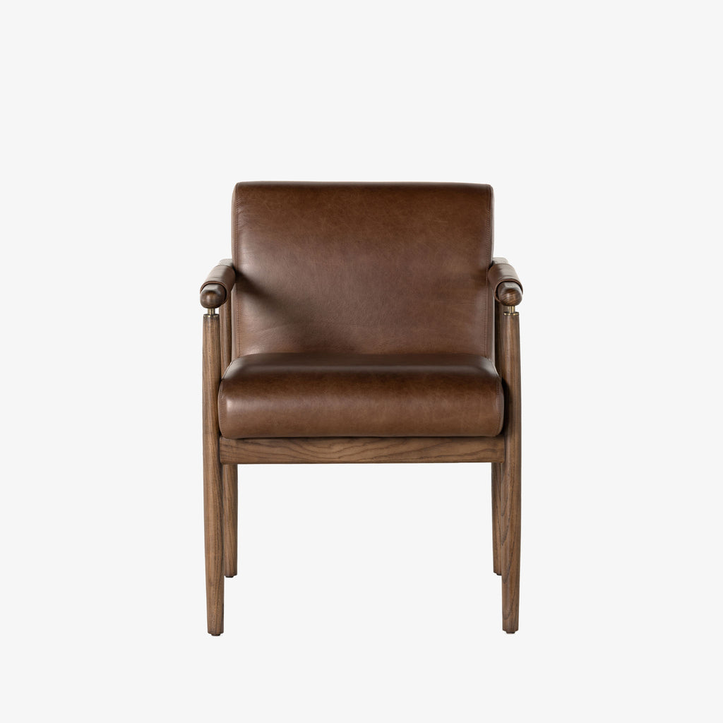 Brown leather 'Markia' arm dining chair with wood frame by four hands furniture on a white background