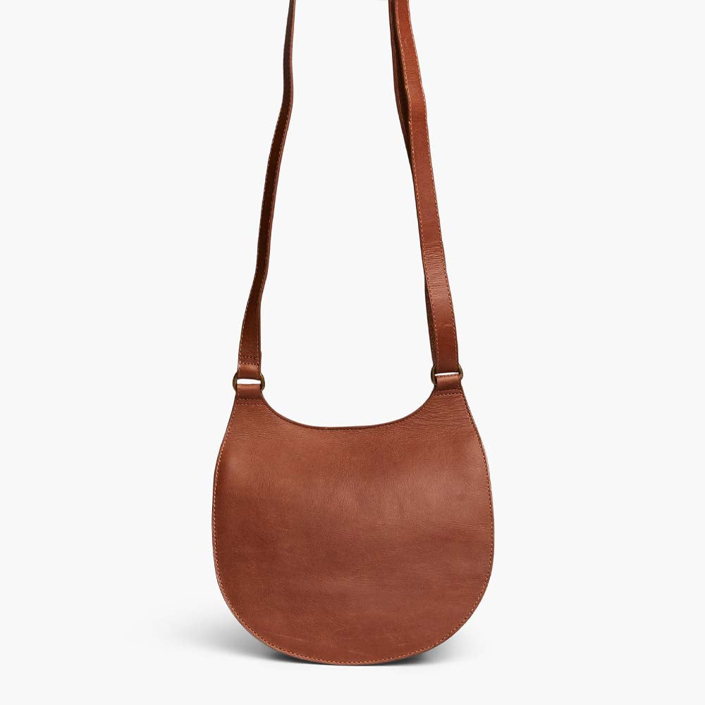 Able brand Martha saddle bag in whiskey color with adjustable shoulder strap on a white background