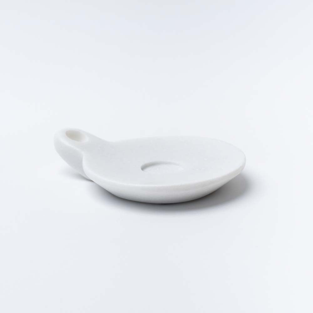 Large white marble dish with handle on a white background
