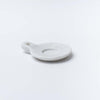 Small white marble dish with handle on a white background