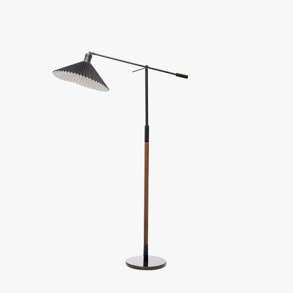 Wood and black metal floor lamp with black pleated shade on a white background