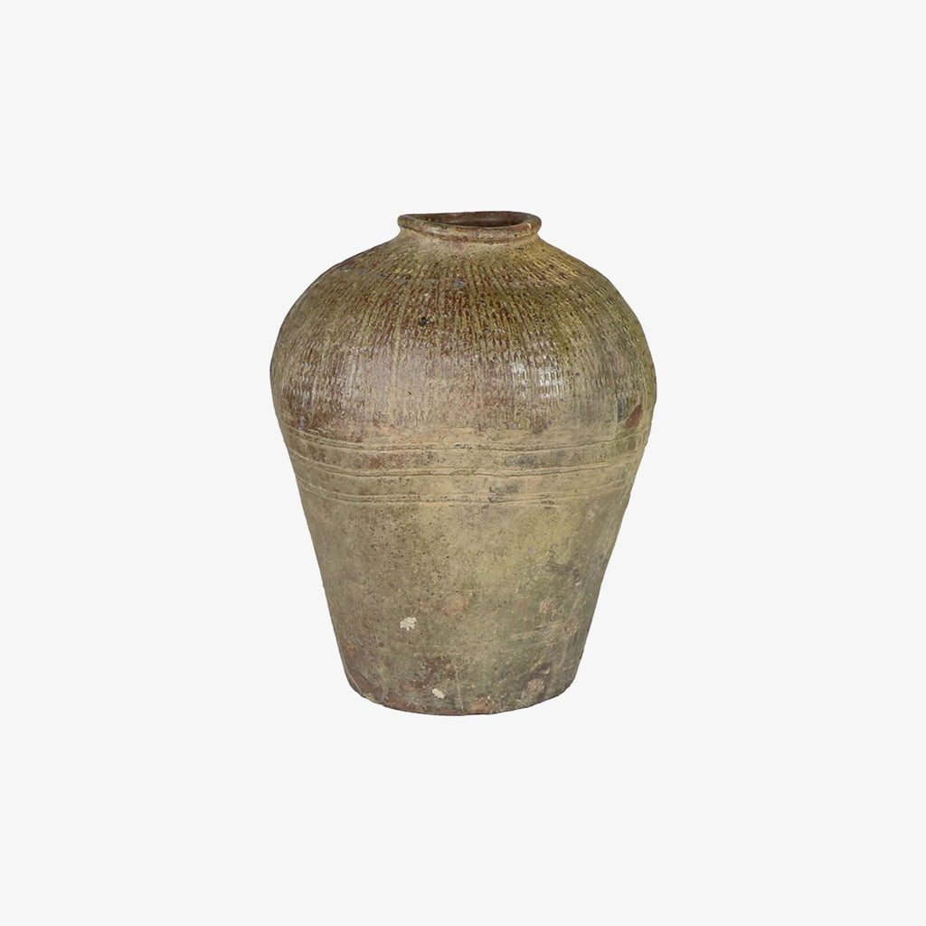 Rustic brown jar like vase with embossed pattern on a white background