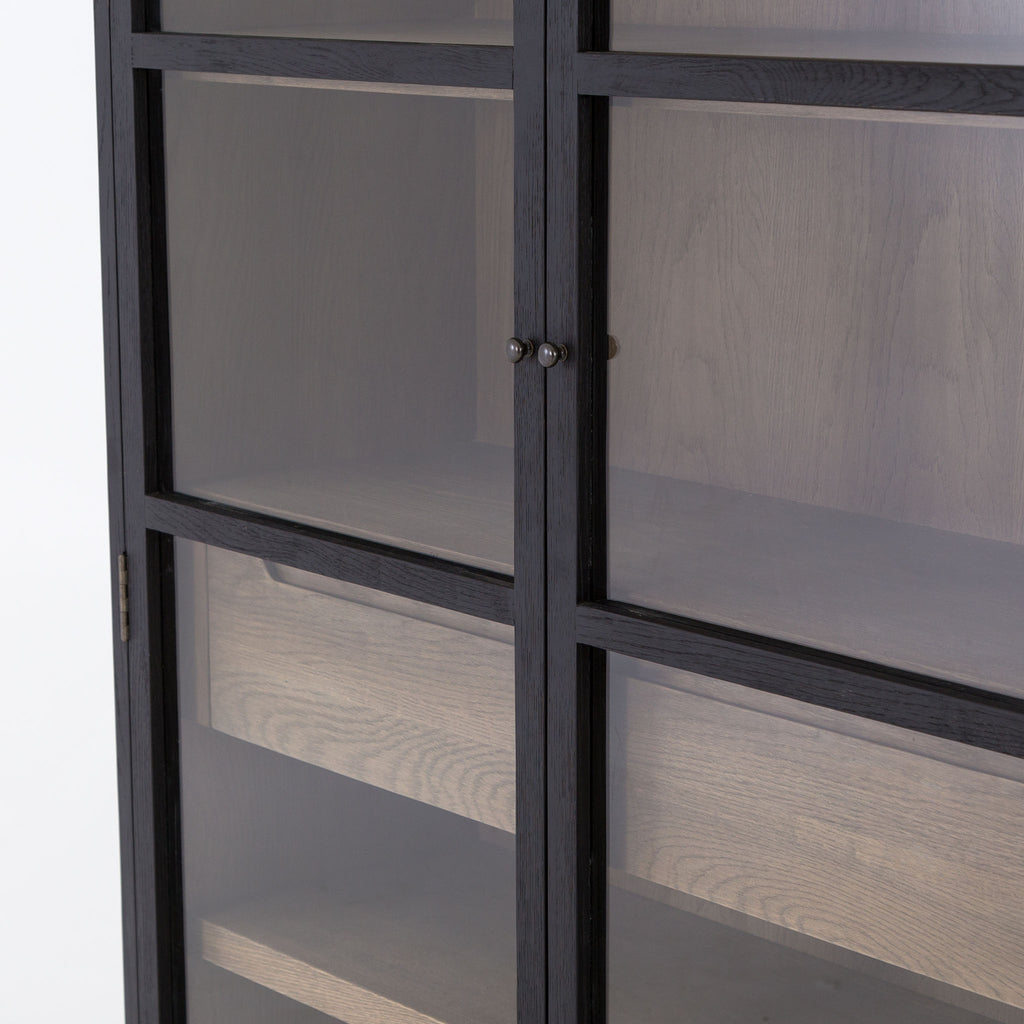 Close up of doors on Four Hands furniture brand Millie black cabinet with two glass doors and oak interior