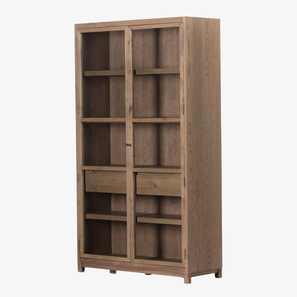Four hands furniture brand Millie oak cabinet with glass doors and four shelves and interior drawer on a white background