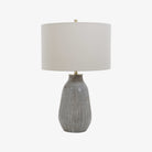 Moynahan Table Lamp on an end table in a living room at Addison West on a white background at Addison West