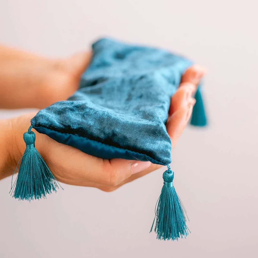 Mer Sea brand moroccan mint aromatherapy eye pillow in blue velvet with tassels help by hands