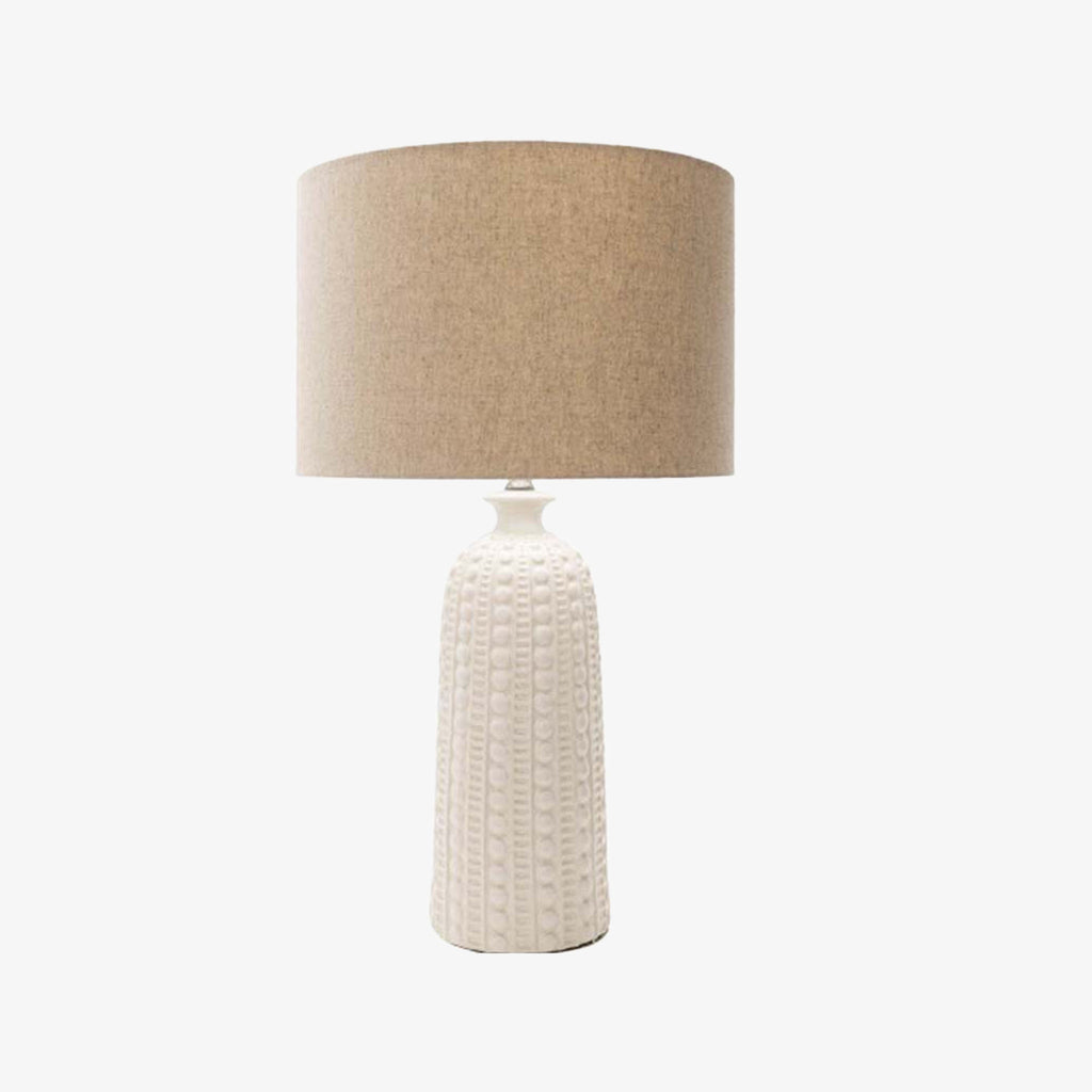 Surya newell table lamp with white ceramic textured finish and linen shade on a white background