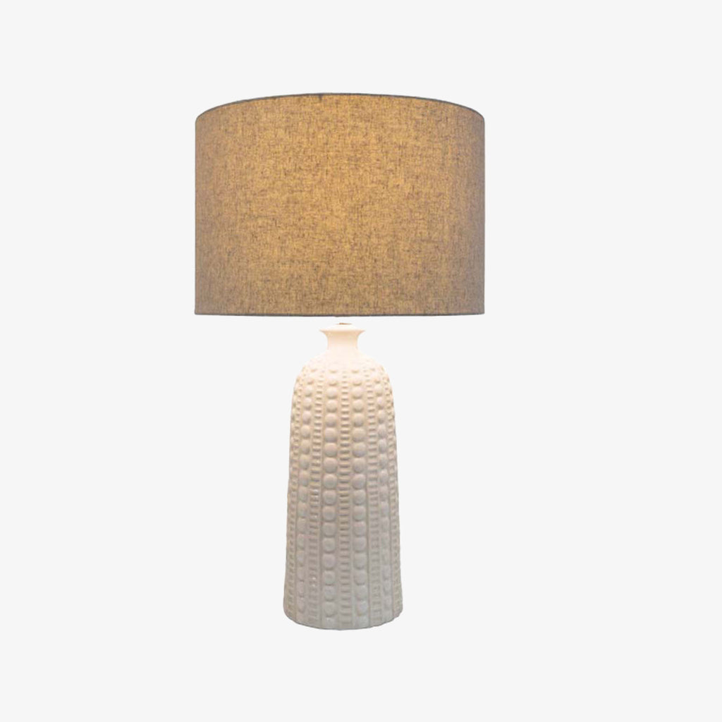 Surya newell table lamp with white ceramic textured finish and linen shade on a white background