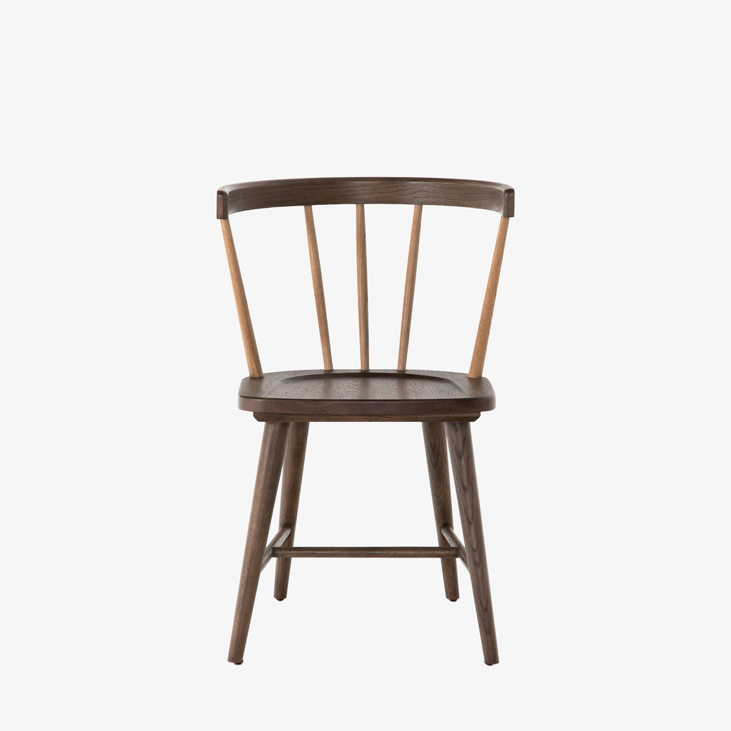 Brown oak 'Naples' Windsor style dining chair with wrap around back and round tenoned back by four hands furniture on a white background