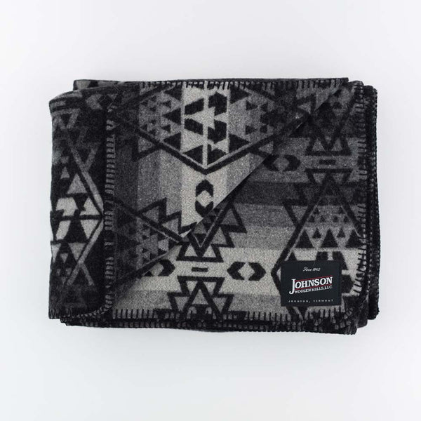 Johnson Woolen Mills wool blanket in charcoal grey aztec print on a white background
