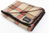 Close up of Johnson Woolen Mills wool blanket in brown, black and beige check print on a white background