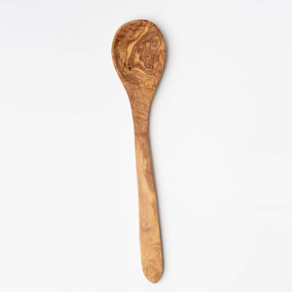 Large olivewood spoon on a white background
