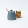 Dark blue Reactive Glaze Stoneware Honey Jar with Wood Honey Dipper on a white background