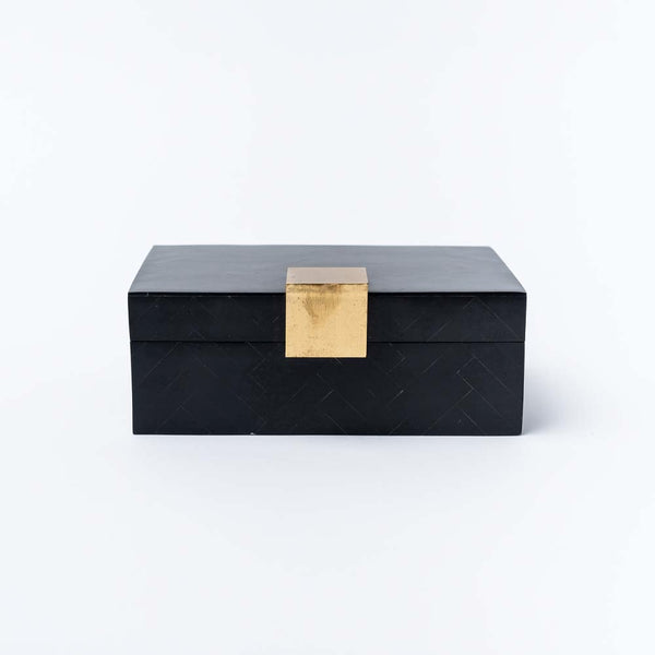 Black accent box with square brass accent on a white background.