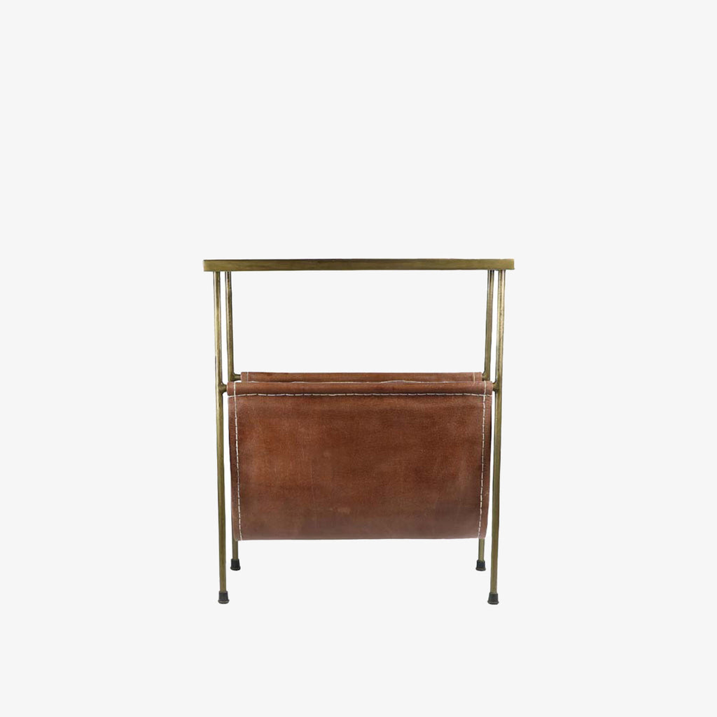Rectangular brass side table with magazine rack leather storage below on a white background
