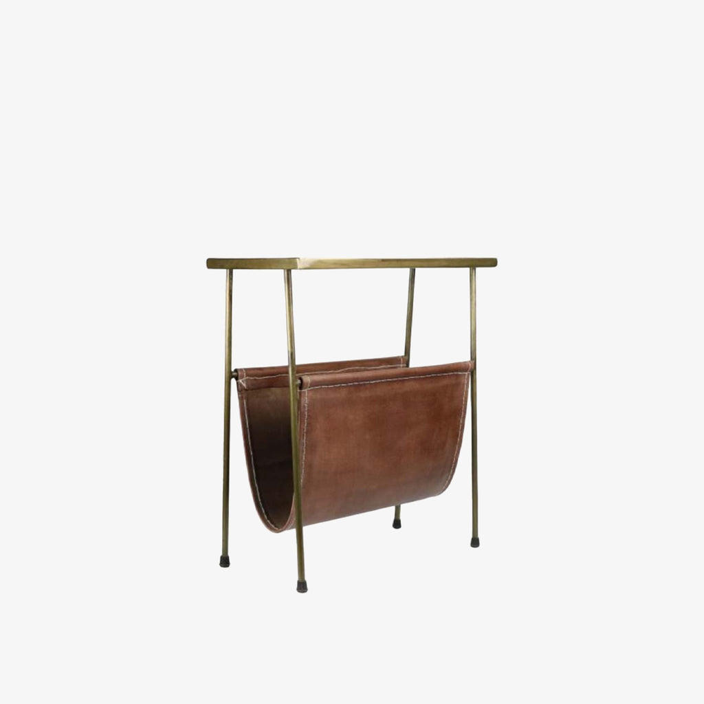 Rectangular brass side table with magazine rack leather storage below on a white background