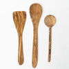Three olive wood cooking utensils side by side on a white background including spatula, large spoon and round face spoon
