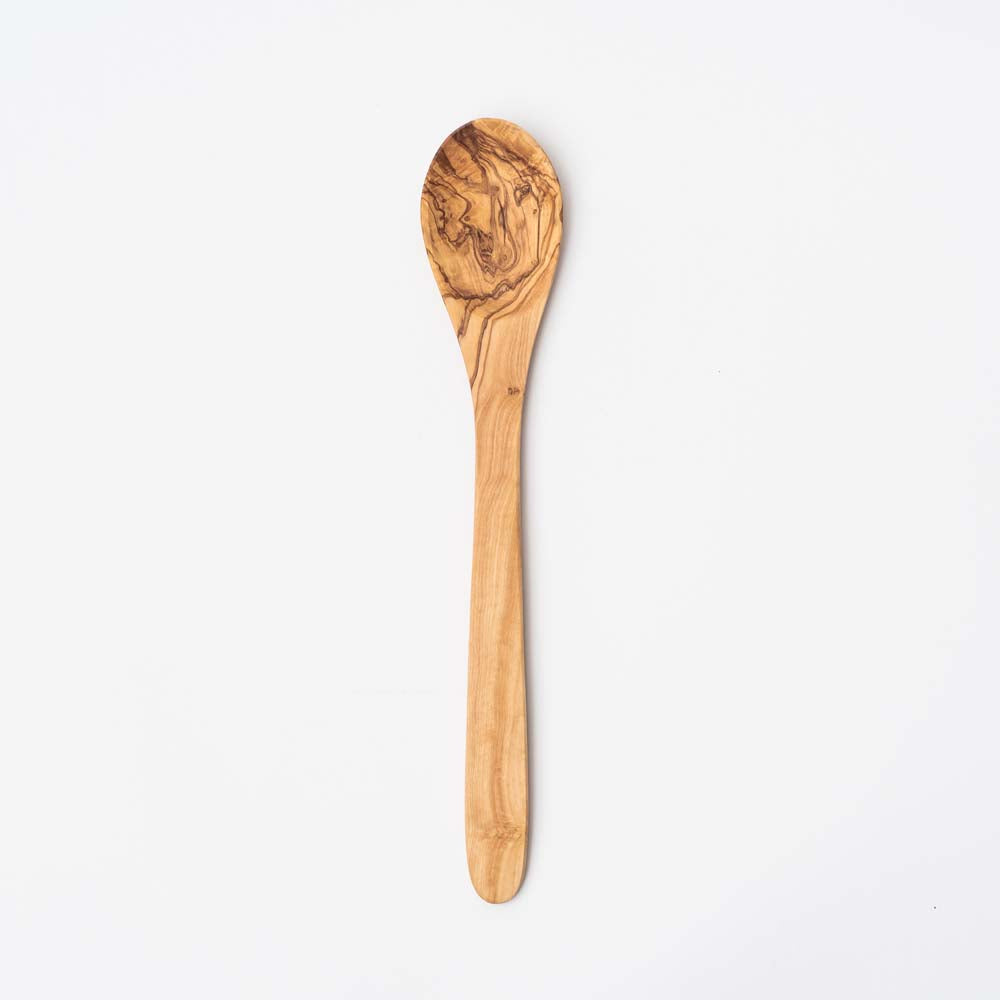 Large olive wood spoon on a white background