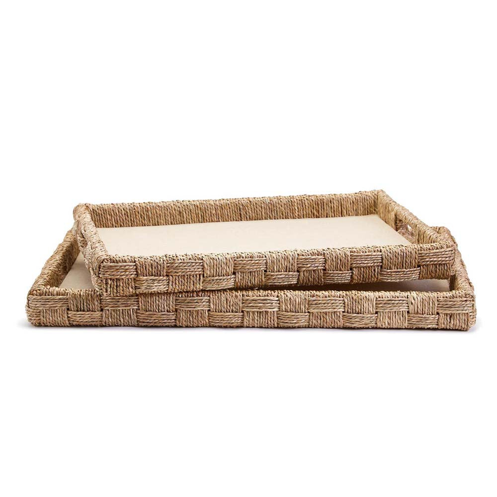 Two rectangular trays with woven seagrass and cotton surface stacked on a white background