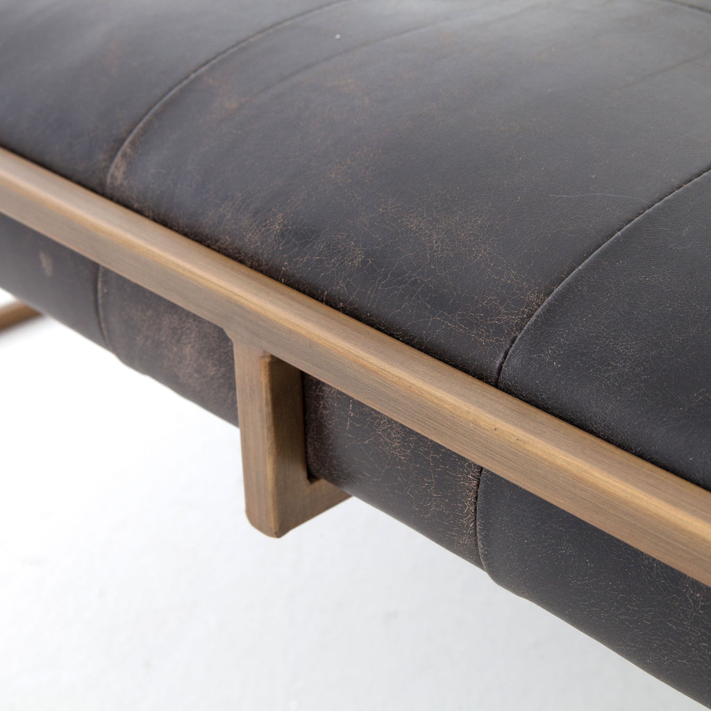 Four hands brand Oxford square coffee table with brass frame and black leather top on a white background