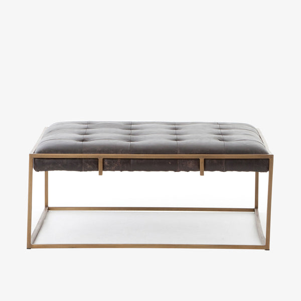 Four hands brand Oxford square coffee table with brass frame and black leather top on a white background