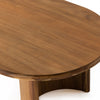 Four hands brand oval wood 'Paden' coffee table on a white background