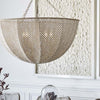 Palecek Quinn Chandelier with Ivory wood and coco beads hanging above a dining table