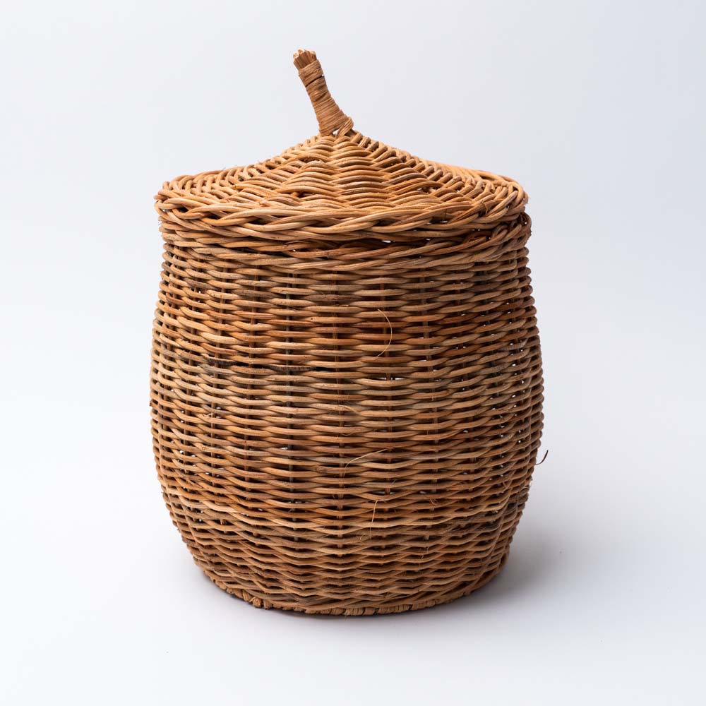 Large Natural wicker basket with lid on a white background 
