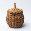 Small natural wicker basket with lid on a white background 