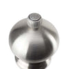 Close up of top of Peugeot Paris brand stainless 7 inch pepper mill on white background