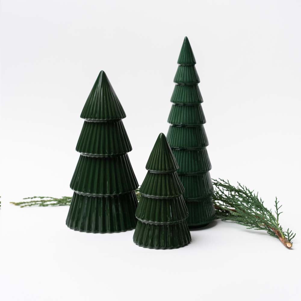 Green ceramic decorative Christmas trees on white background