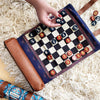 Pendleton brand chess and checkers set being plays on a white shag rug 
