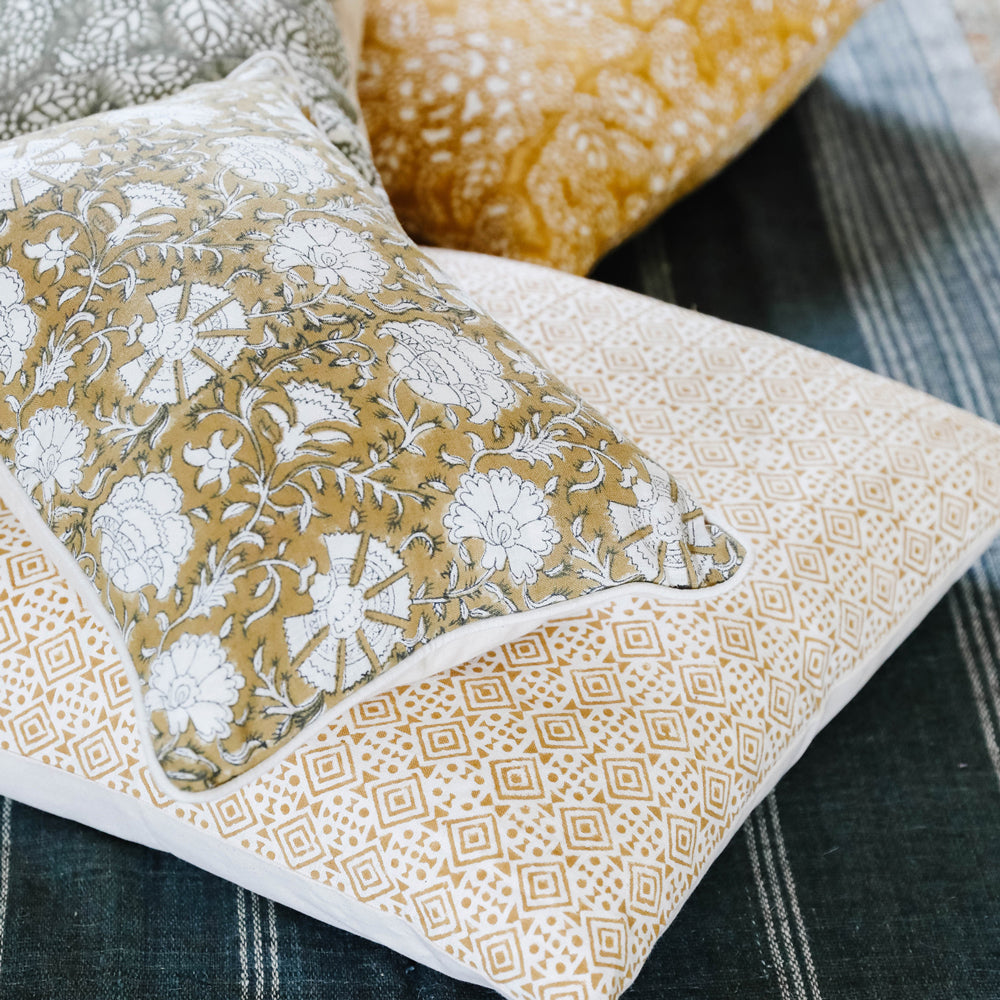 Filling spaces brand 'Nisa ' print floral mustard lumbar throw pillow on a bench
