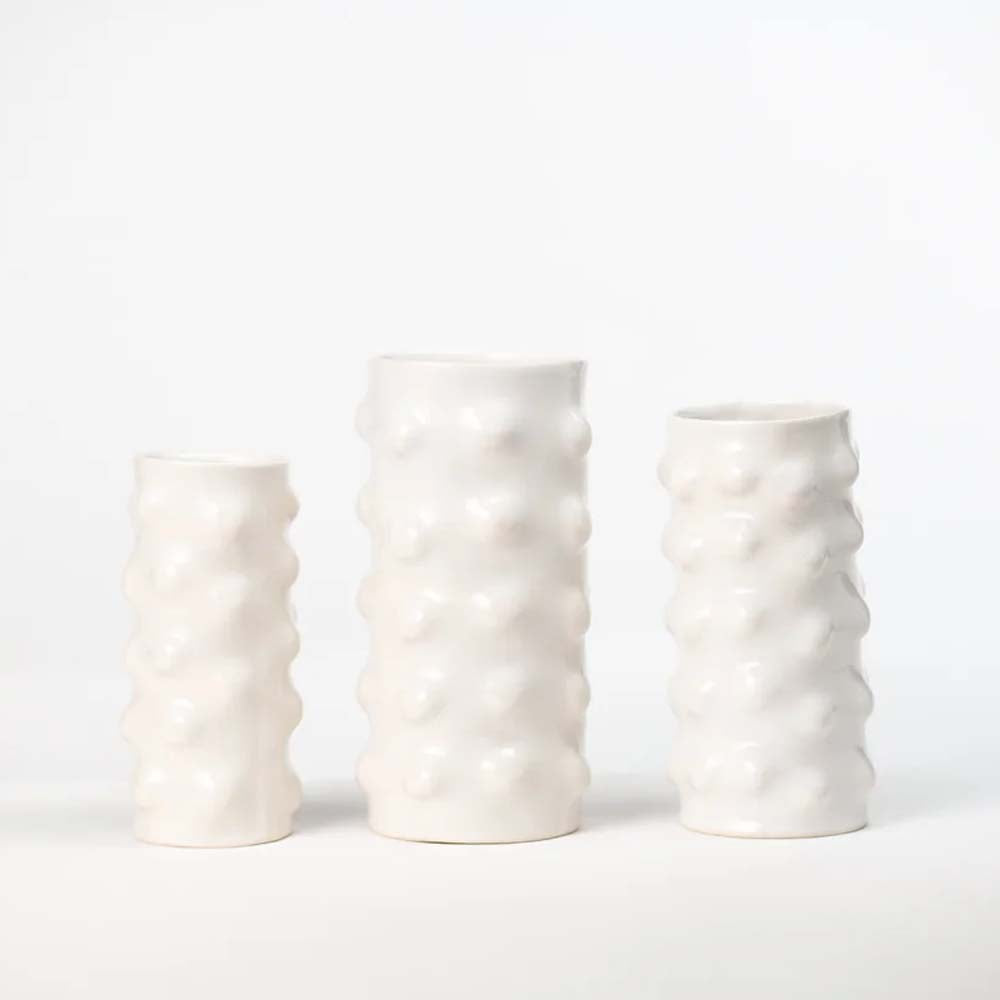 Three Stephanie Grace ceramics polka dot vases together on a white background