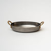 Nicolas Vahé brand metal presentation pan with brass handles on a white background