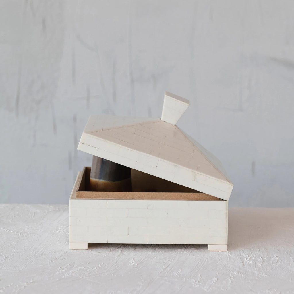 Pyramid Resin Box propped open on a white textured background