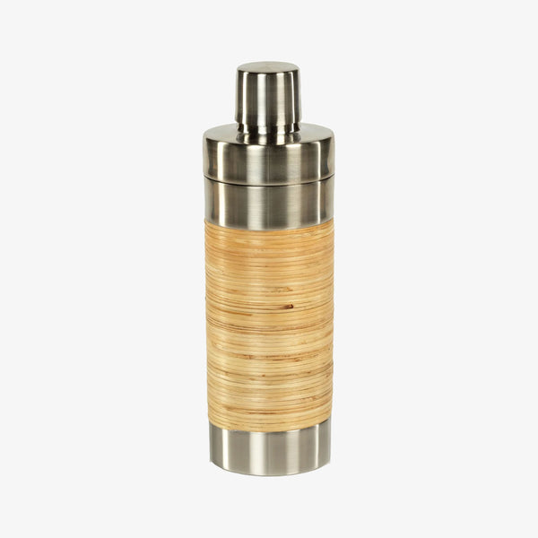 Metal cocktail shaker wrapped in rattan on a white background