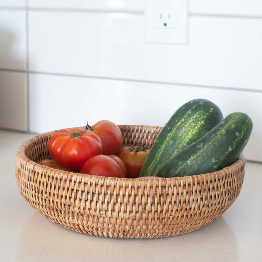 Rattan bowl with vegetables on a white background