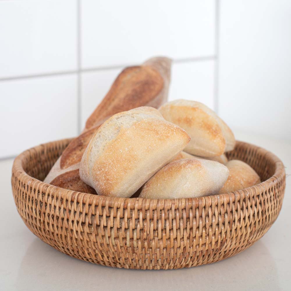 Rattan bowl with bread on a kitchen counter