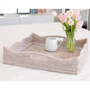 Square whitewashed rattan tray with scallop edge and two handles on a counter with vase and mug