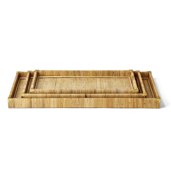 Set of three rattan rectangular trays with brass corners on a white background