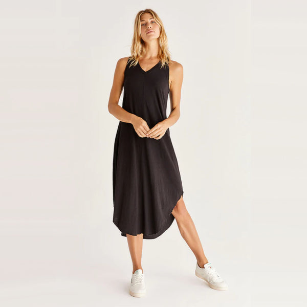 Blond model wearing Z Supply Reverie Midi Dress in Black with white sneakers in front of a white backdrop