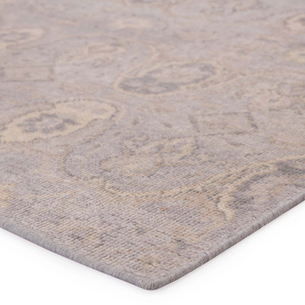 Side view close up of Jaipur living REVOLUTION - REL11 rug in neutral beige and gray tones on a white background 