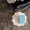 Jaipur living REVOLUTION - REL06 rug with light brown background and blue baroque inspired pattern with leather chair and marble top cocktail table