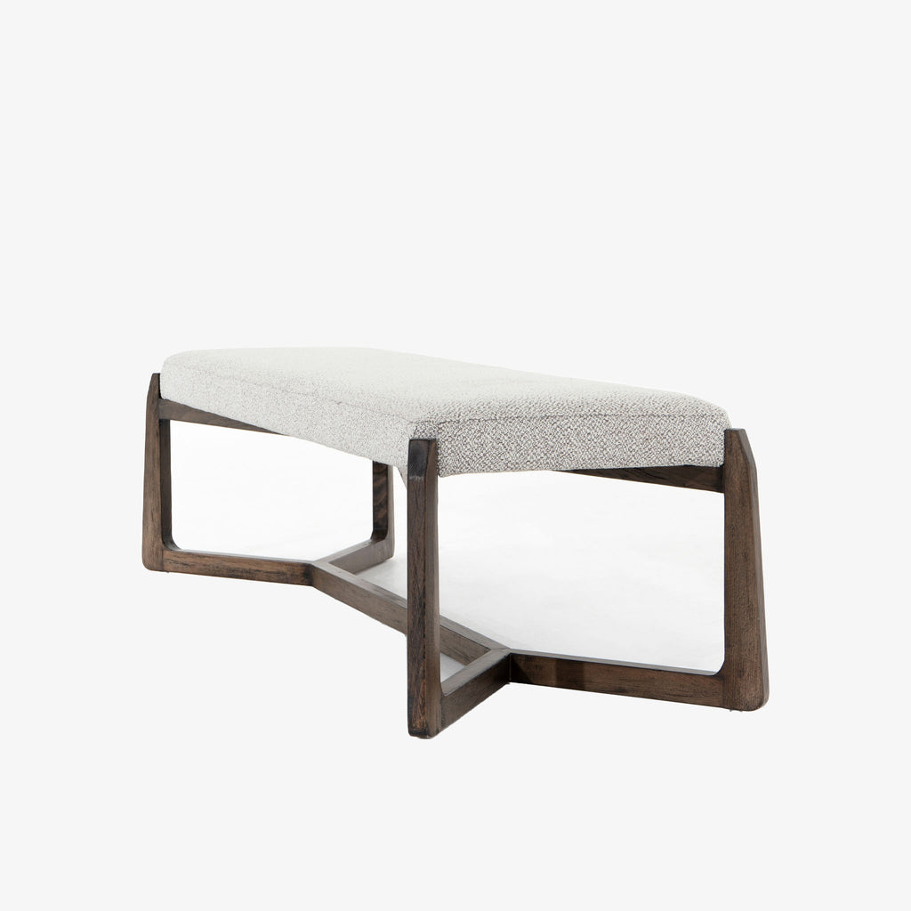 White upholstered 'Roscoe' bench with cross brace wood frame  by four hands furniture on a white background