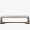 White upholstered 'Roscoe' bench with cross brace wood frame  by four hands furniture on a white background