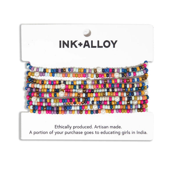 Ink and Alloy ten strand multicolor stretch bracelets on a white background